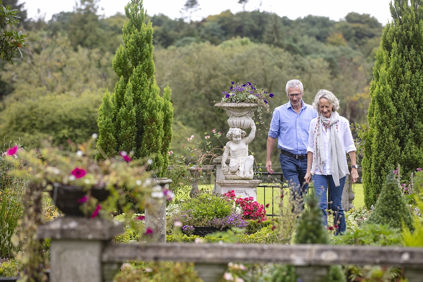 A couple walking in the gardens of Blessingbourne Estate