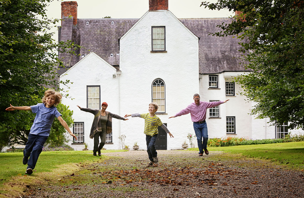 Children running outside Springhill House in Moneymore