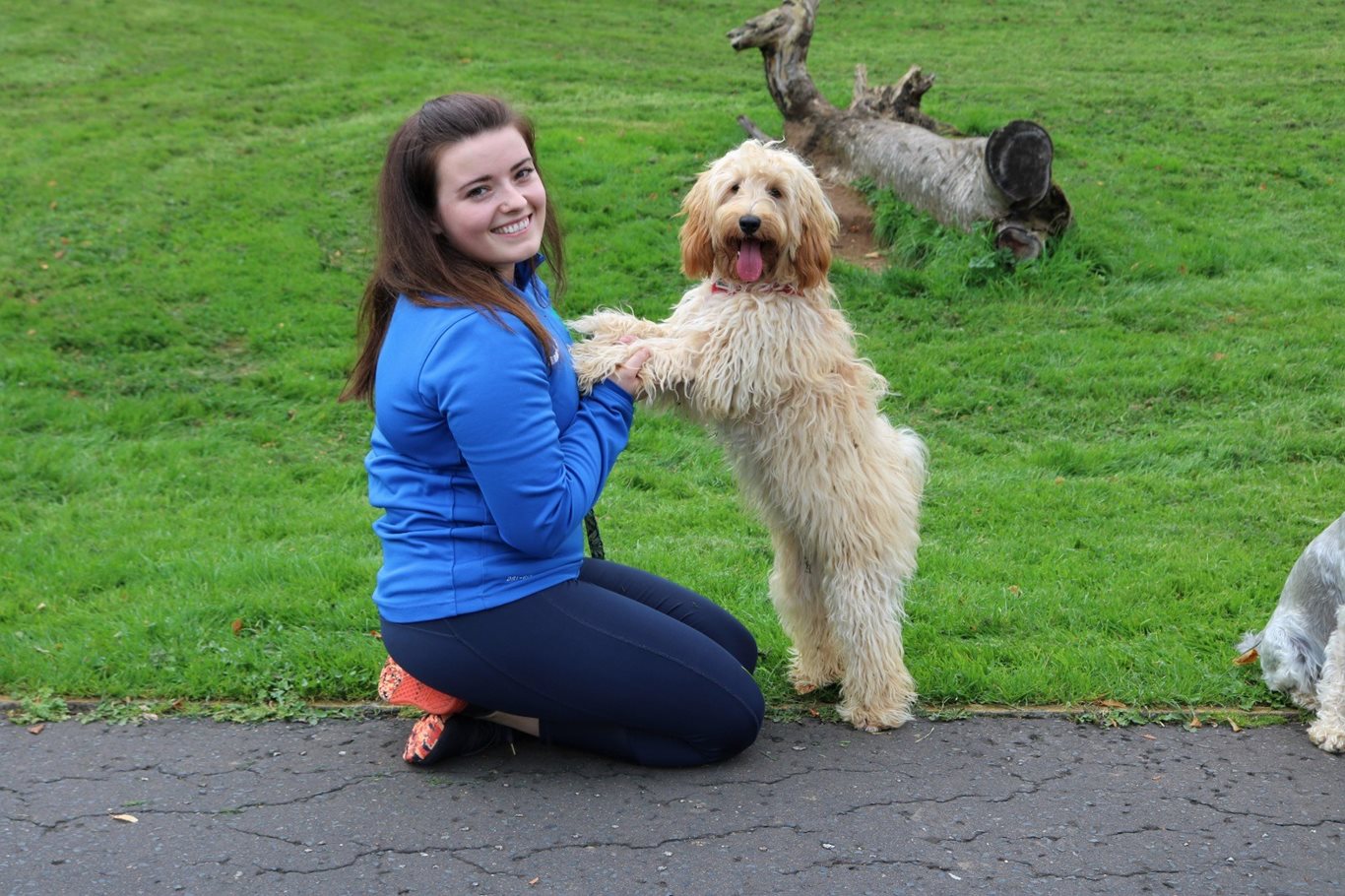 Rebecca Greenaway GOGA Coordinator with a puppy on the grass